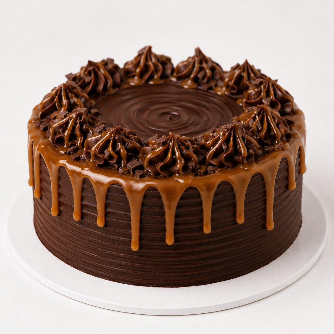 Eggless classic chocolate cake with smooth ridged buttercream finish, piped chocolate rosettes, chocolate chip sprinkles and star border.Freshly baked and available to order online at Pam's Bakery, Sector 75, Spectrum Metro Mall, Noida
