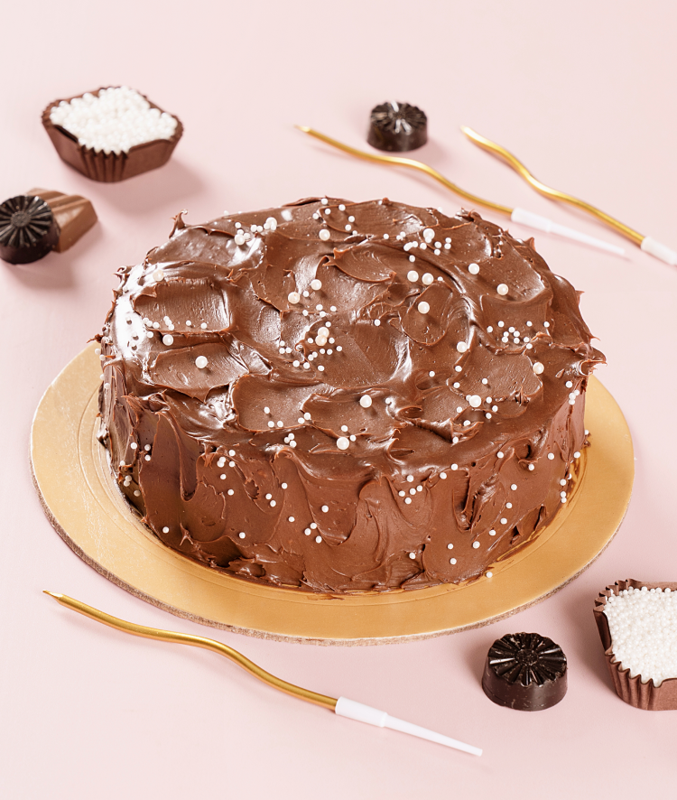 Eggless chocolate truffle cake with rich dark chocolate ganache frosting, white pearl sprinkles and gold birthday candles . Freshly baked and available to order online at Pam's Bakery, Sector 75, Spectrum Metro Mall, Noida
